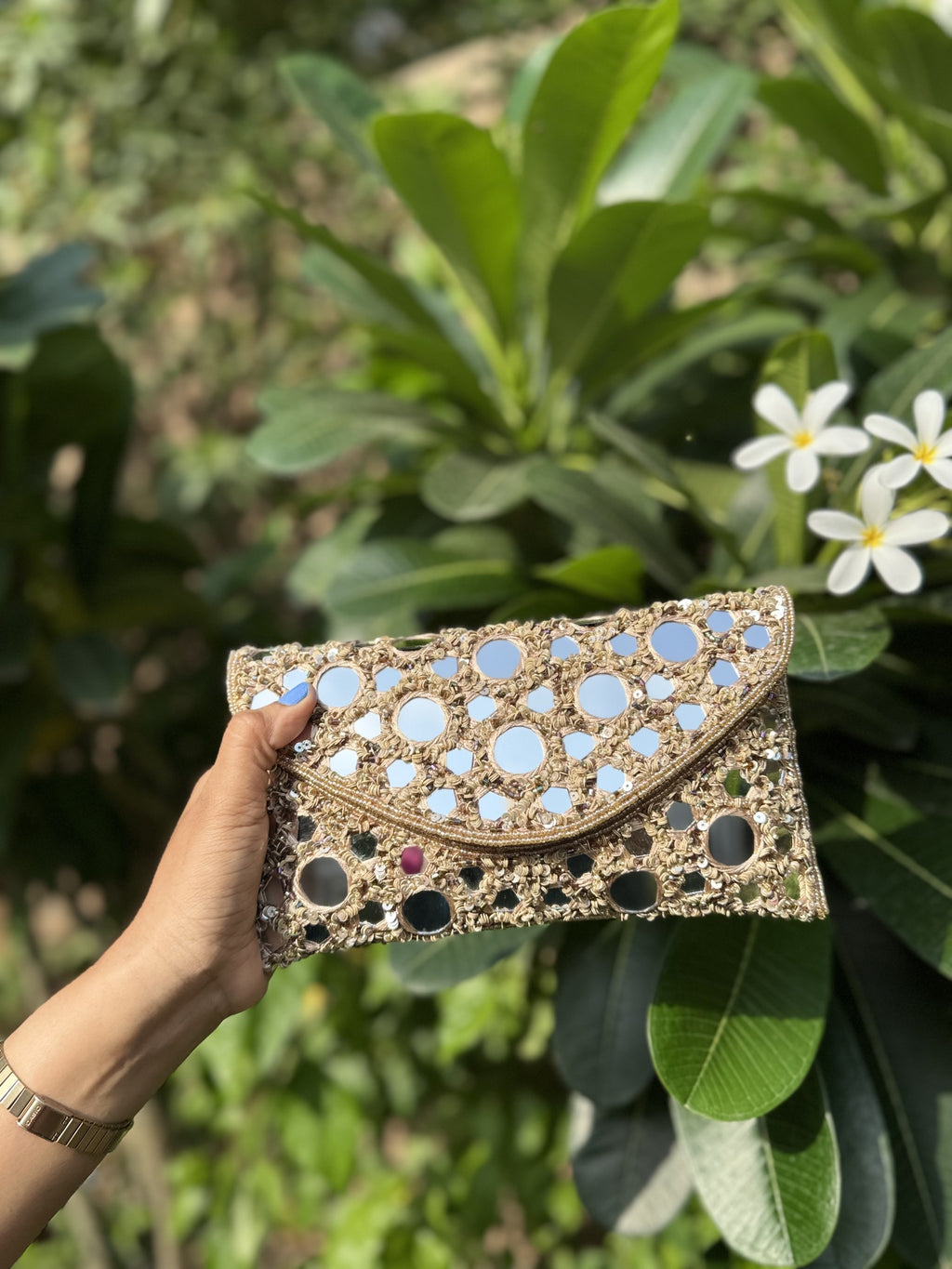 Side profile of the Sheesha Flap clutch, illustrating its structured rectangular depth.