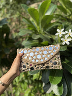 Side profile of the Sheesha Flap clutch, illustrating its structured rectangular depth.