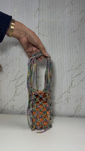 Front view of the Soul Glo Statement Bag displaying its multi-tone shimmering fabric.