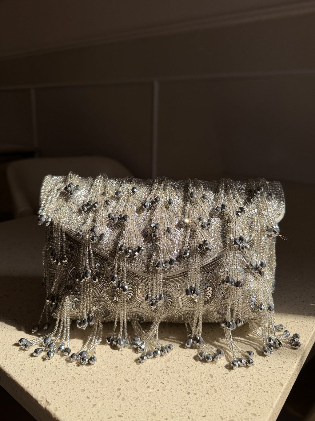 Starlace flap bag displaying its heavy hand embroidery and cascading tassels.