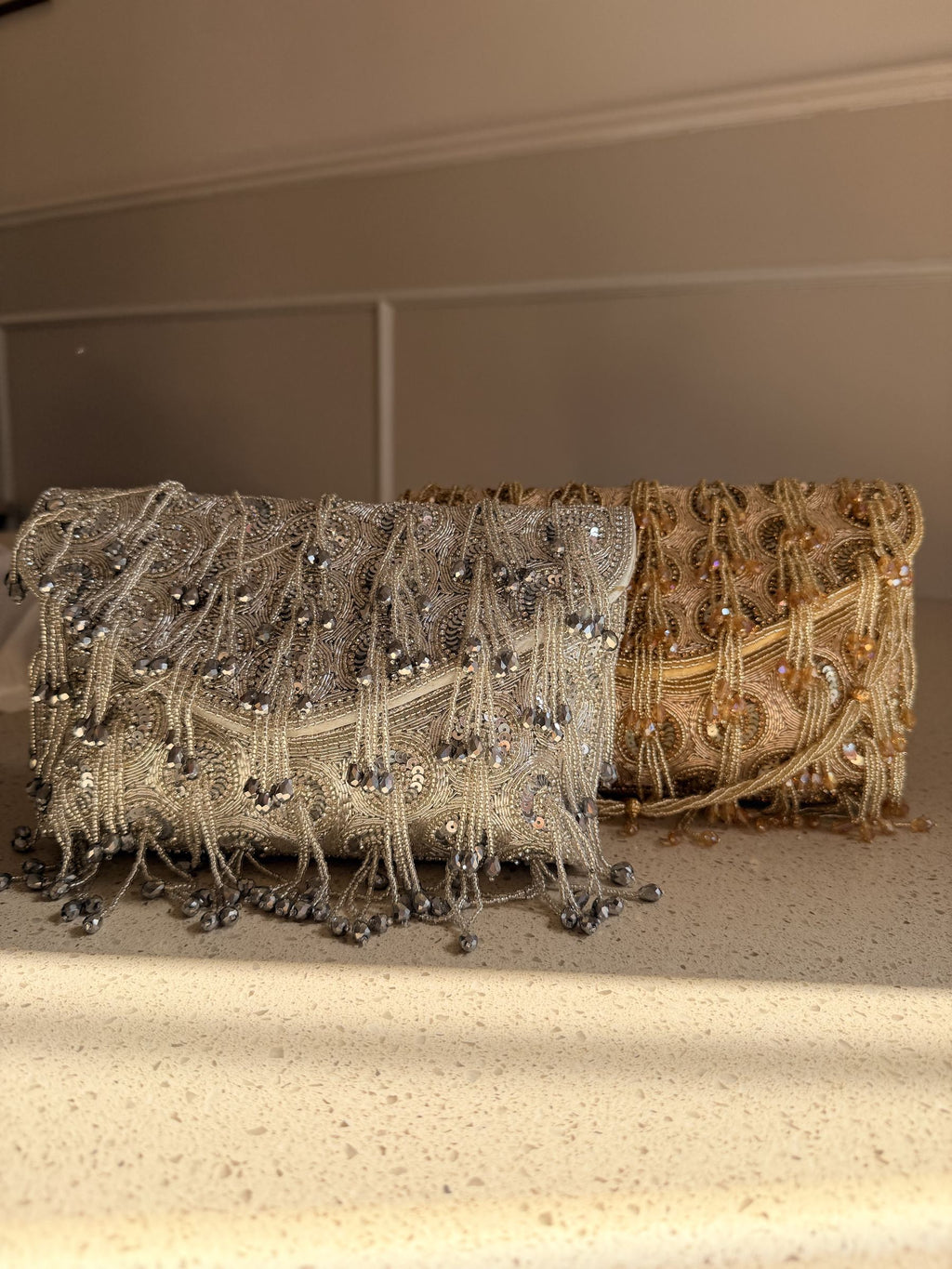 Lifestyle layout of the Starlace flap bag next to elegant cocktail wear and gold jewelry.