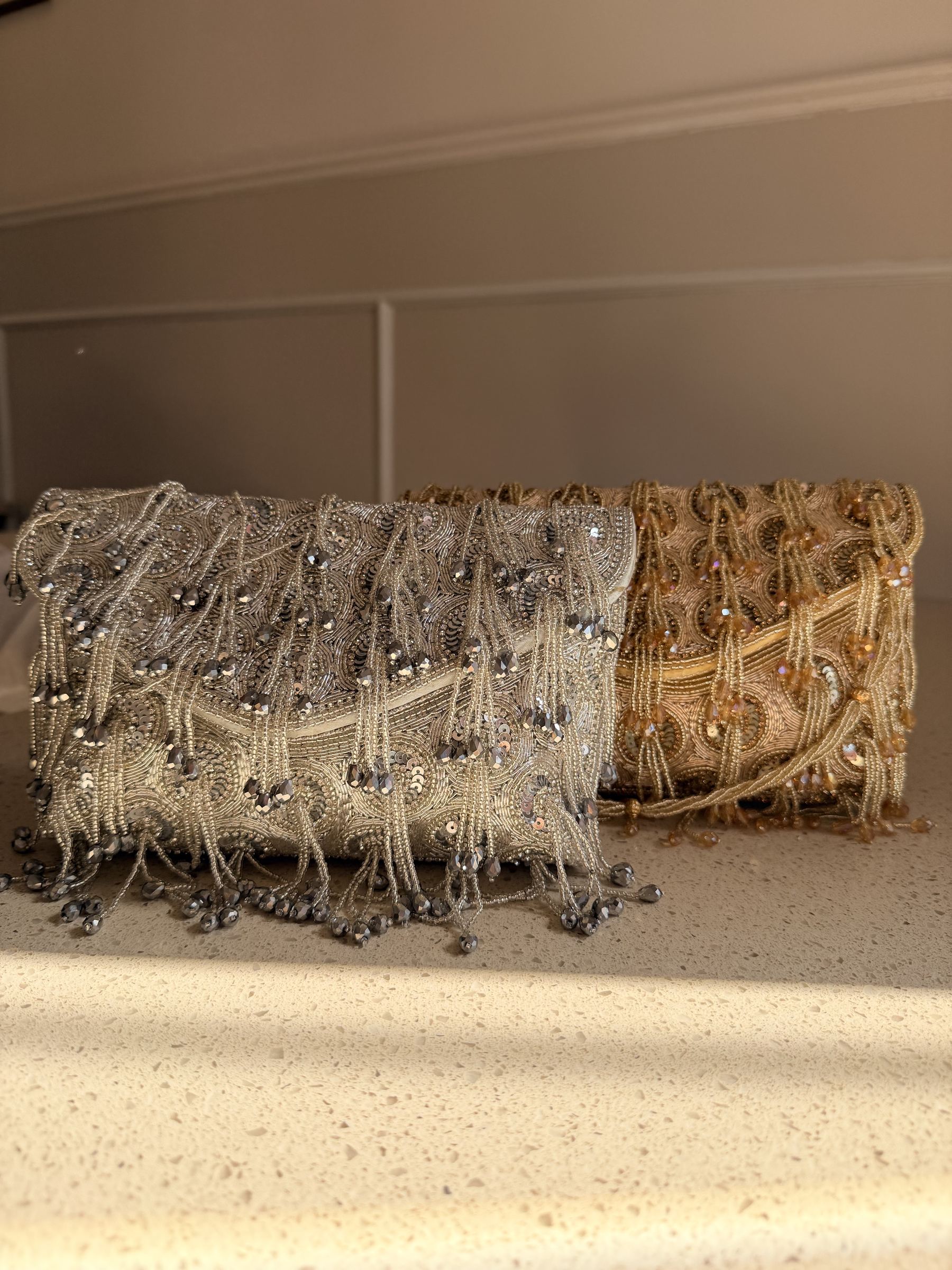 Lifestyle layout of the Starlace flap bag next to elegant cocktail wear and gold jewelry.