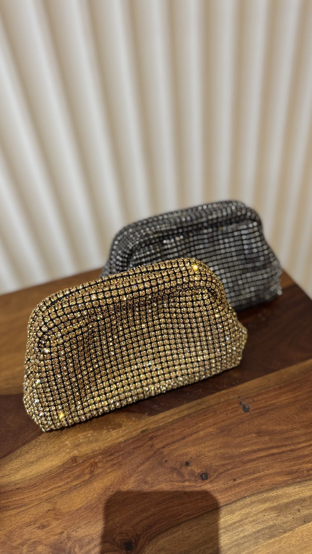 Model styling the Starlit bag handheld with a shimmering black dress.