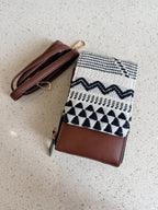 The organizer sling bag held open, displaying multiple internal sleeves and card slots.