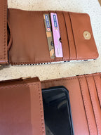 The Strap and Stow bag lying flat with travel essentials: passport, keys, and phone.