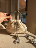 Suede frame clutch in rich napped texture displaying its gold frame and clasp lock.
