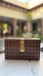 Side angle view displaying the rectangular box thickness and polished brass corner fittings.