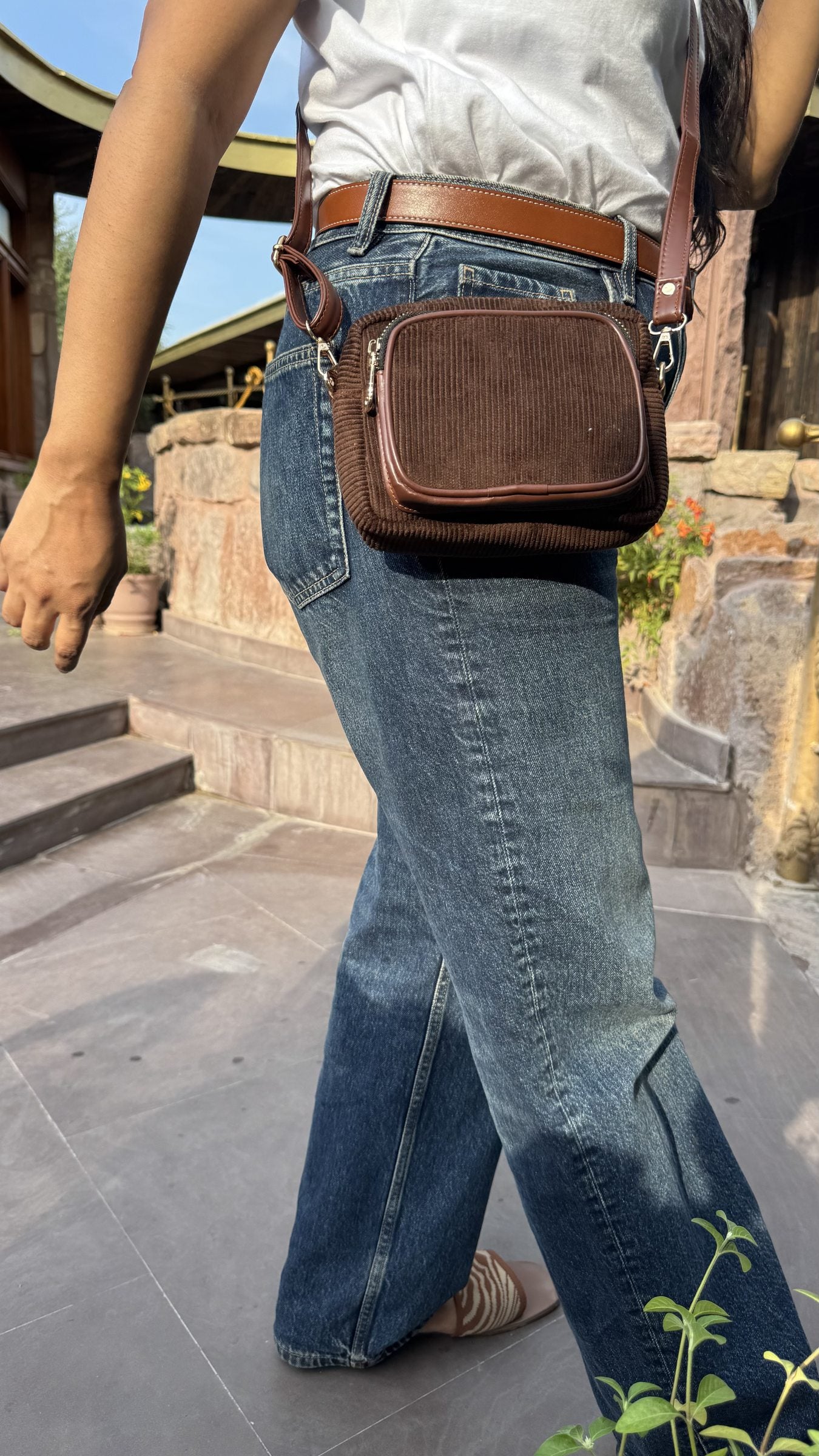 The Corduroy Edit sling zipped open, showing the internal fabric lining and slip pocket.