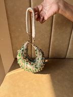 Front view of The Opal Edit Bag displaying its unique sculpted, organic silhouette and hand-beaded details.