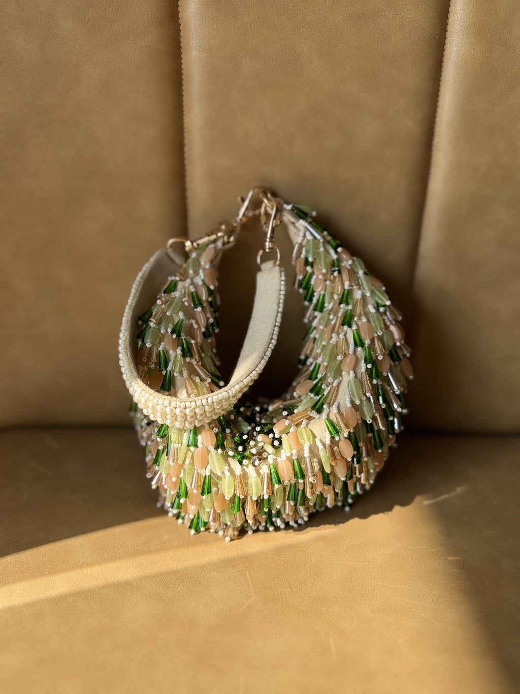 Detailed close-up of the intricate glass beading on the sculpted frame.