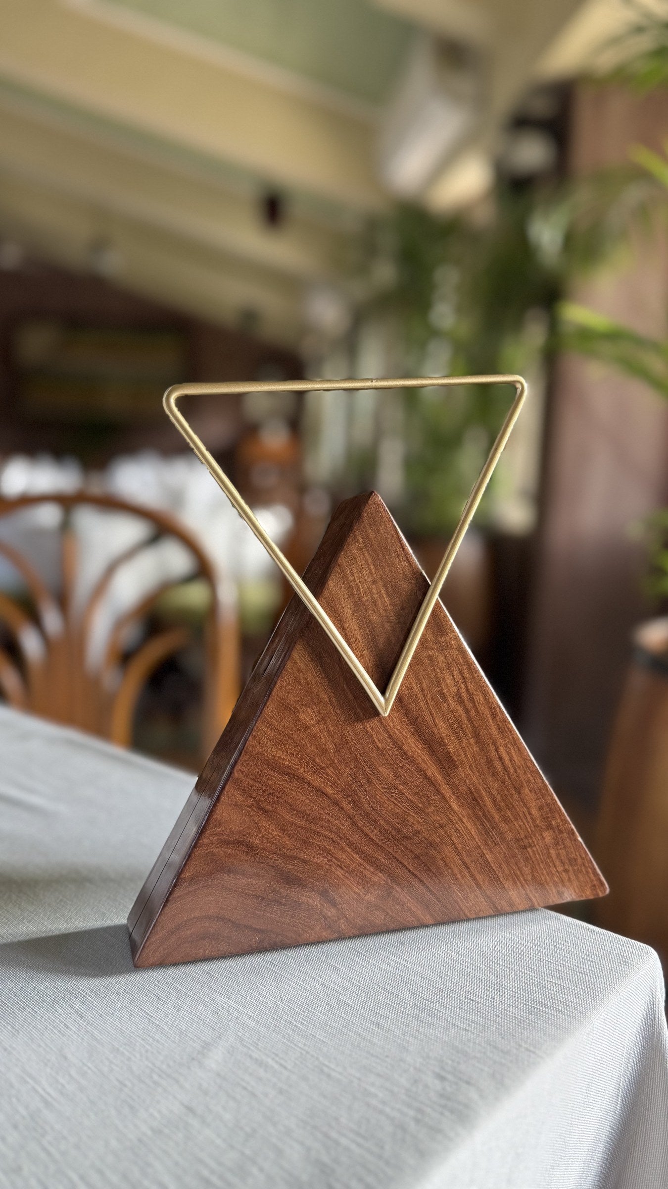 Model styling the Trikon Luxe clutch handheld to showcase its artistic statement appeal.