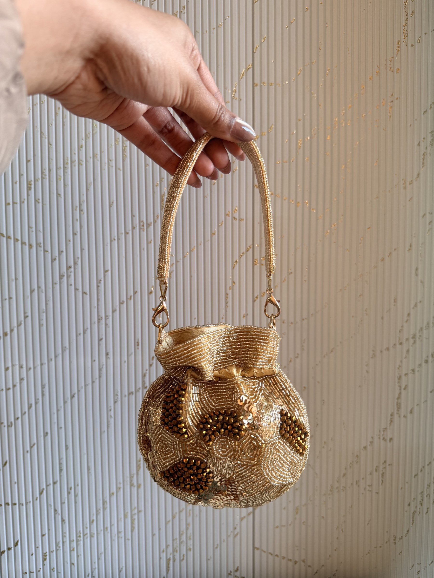Detailed close-up of the glass beads and pearls hand-sewn onto the velvet canvas.
