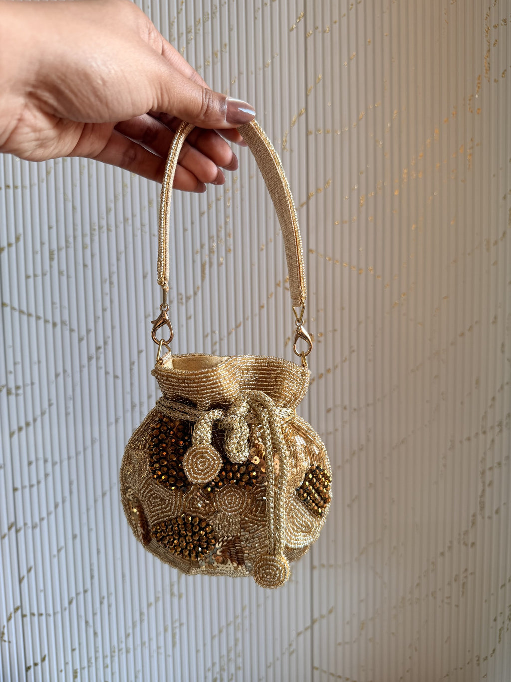 Open view of the mini potli displaying its fabric lining and internal space for lipstick.