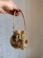 Open view of the mini potli displaying its fabric lining and internal space for lipstick.