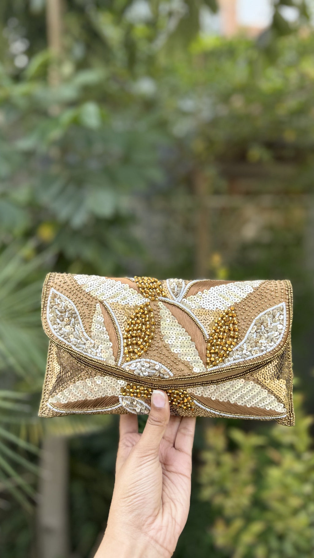 Side angle of the Zaraa Blossom clutch, showing its slim depth and clean fabric borders.