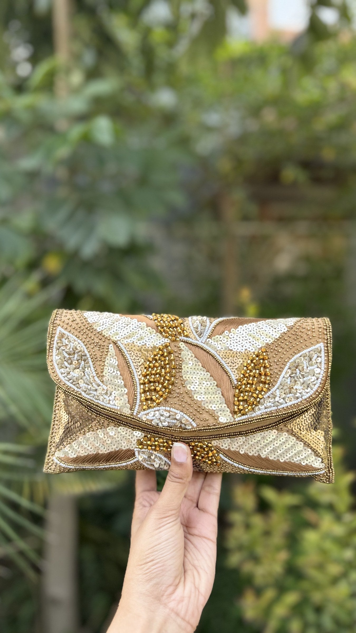Side angle of the Zaraa Blossom clutch, showing its slim depth and clean fabric borders.
