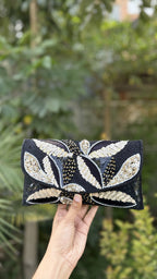 Open view of the Zaraa Blossom handbag showing the fabric lining and secure magnetic snap button.