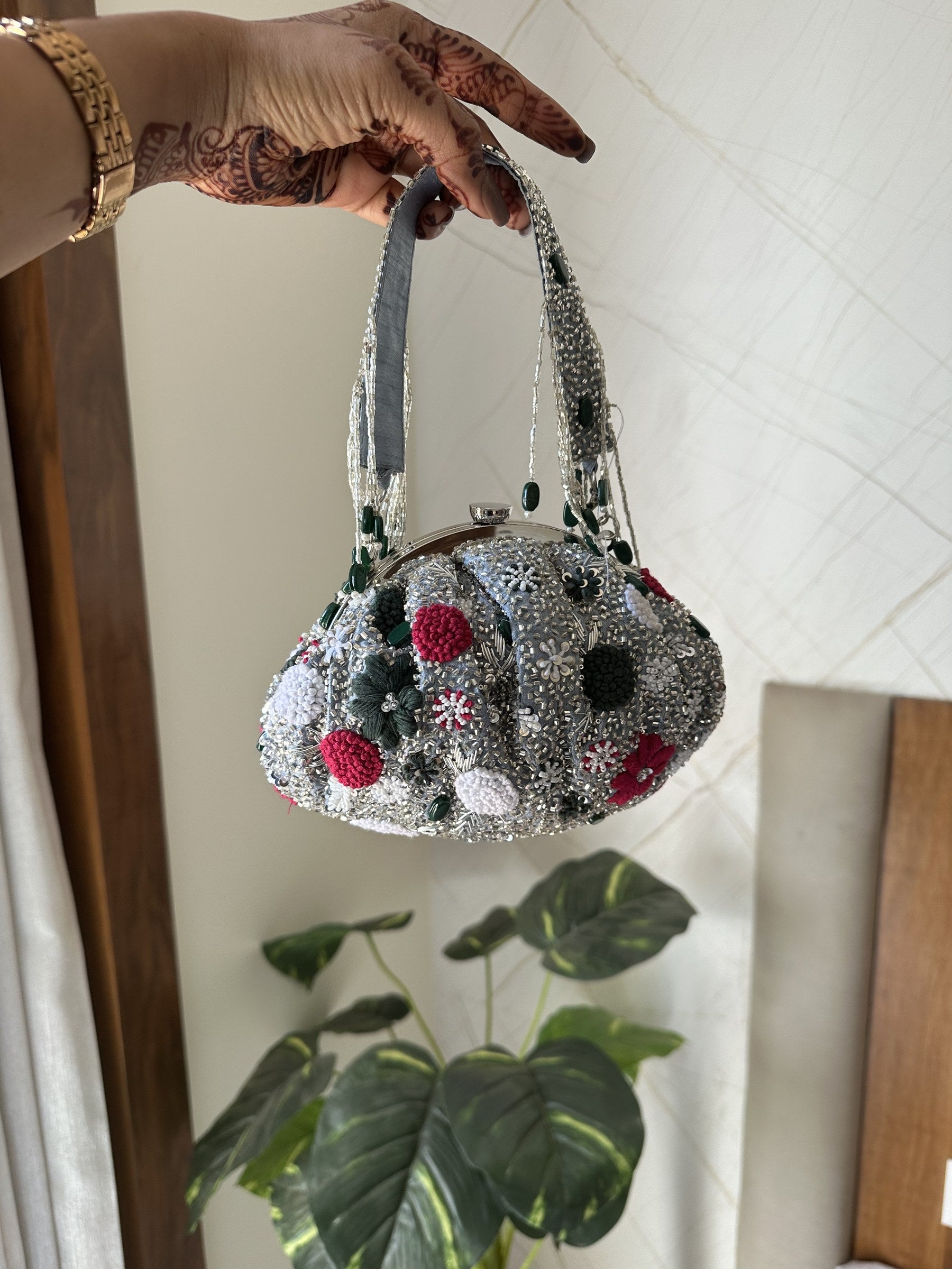 Side panel view of the Zari Batua showing its soft pouch width.