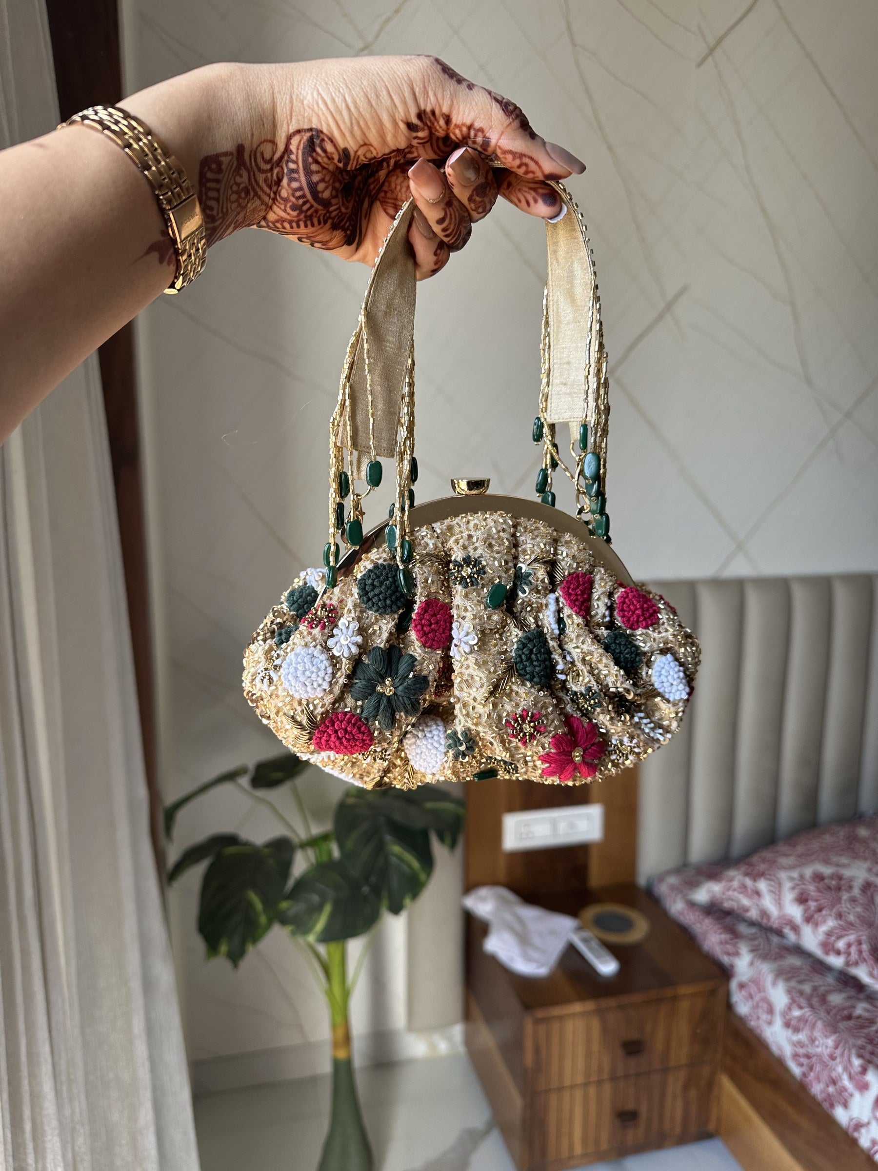 Top view of the Zari Batua highlighting the wristlet loop and drawstring opening.
