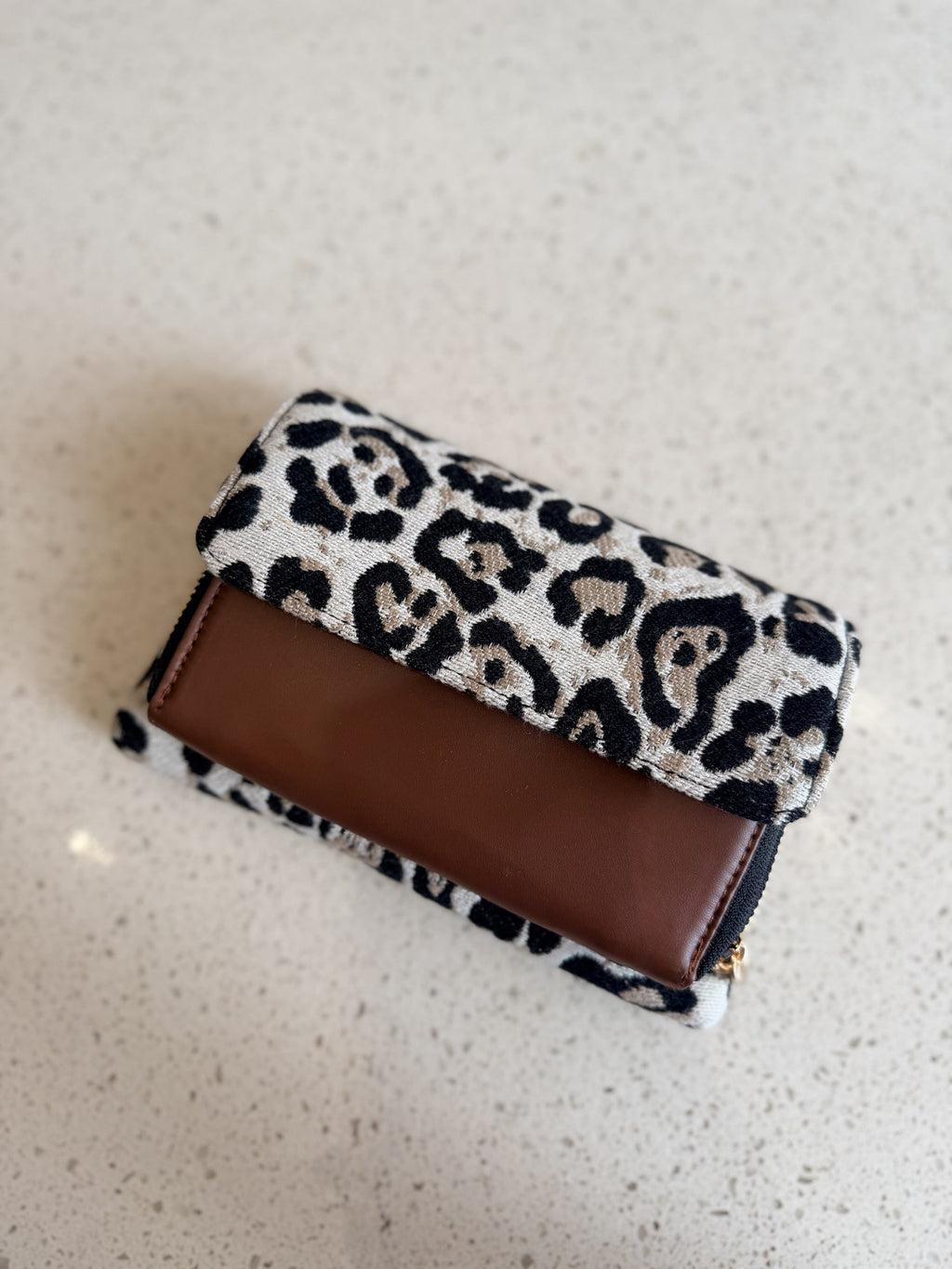 Front view of the Zinga Flap Organizer Sling closed, displaying its clean charcoal grey canvas cover.