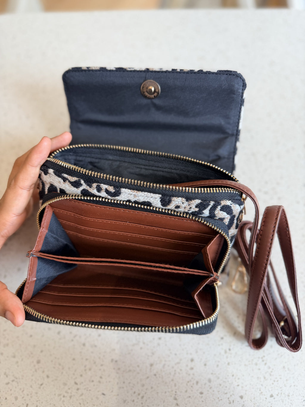 The Zinga Flap open, showing the two separate interior compartments lined in black fabric.