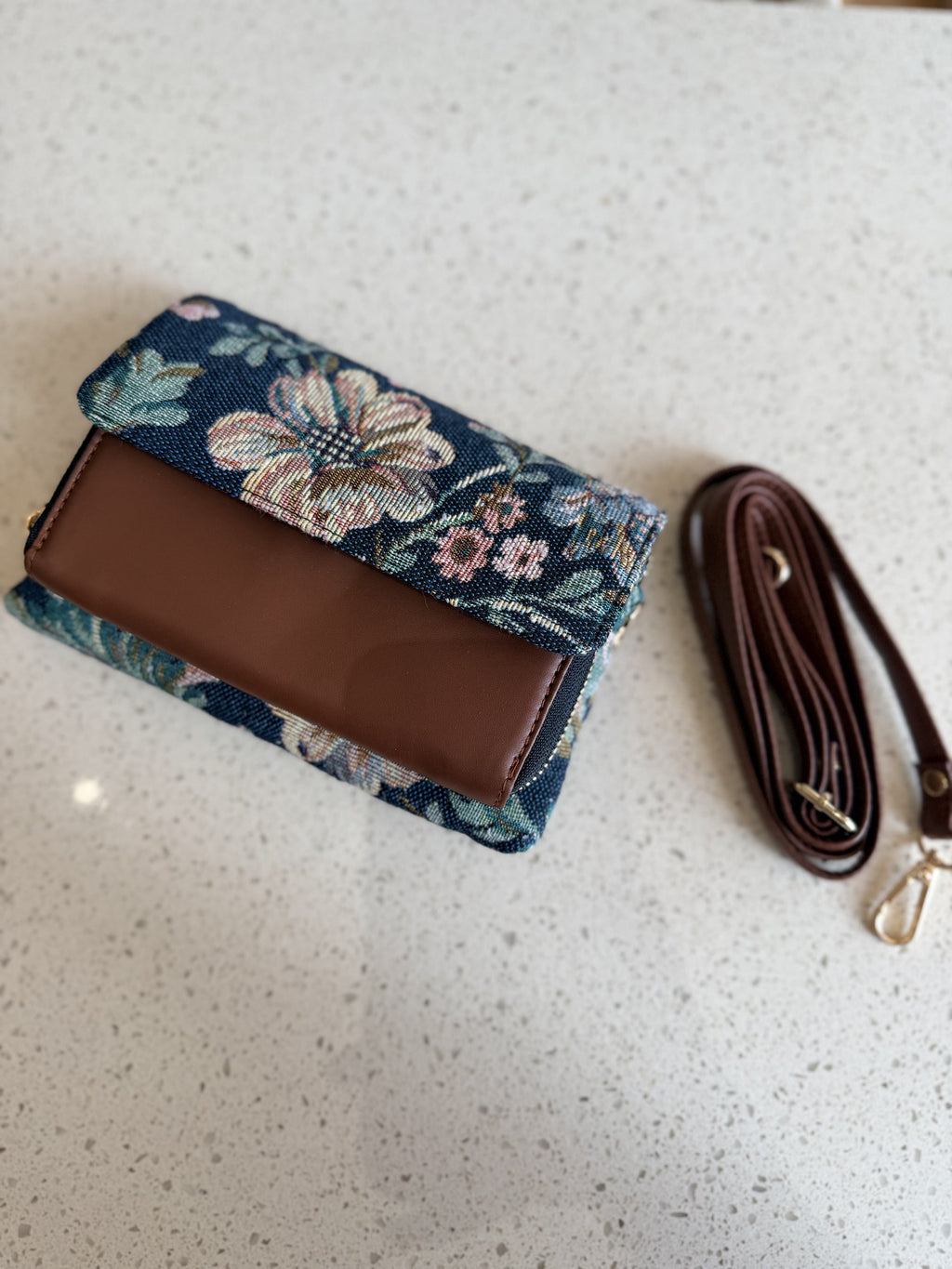 A close-up of the durable synthetic leather trims outlining the flap borders.